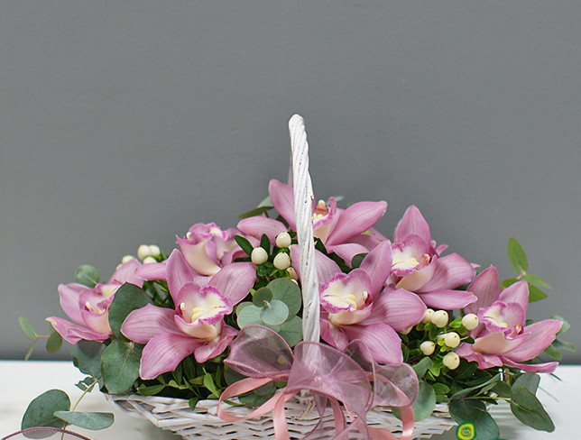 Basket with pink orchids photo